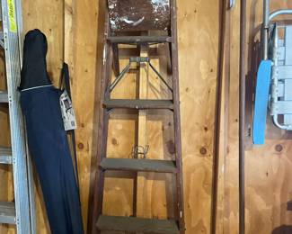 Wooden ladder, rake, lawn chairs