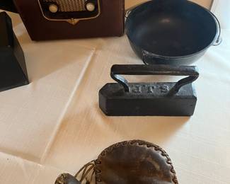Antique zenith working radio, iron kettle, flat iron and antique baseball mitt.