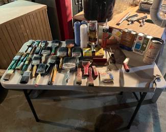Variety of paint brushes and rollers.