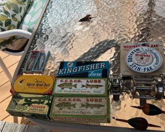 Vintage fishing Lures and boxes, fishing reels and antique fishing bobbers.