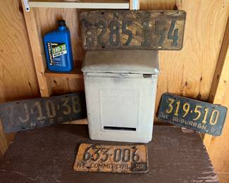 Antique and vintage license plates and vintage mailbox.