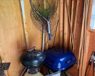 Two weber grills and fishing nets.