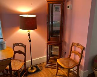 Lighted curio cabinet, brass floor lamp and brass bucket.
