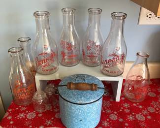 Antique milk bottles from Seneca farms and White spruce farms both located in Geneva and enamel pot with bale handle and lid.