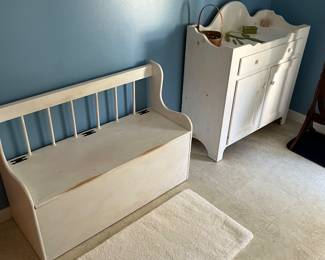 Washstand, storage bench and throw rug.