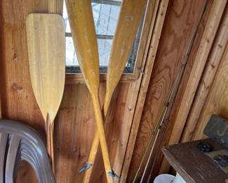 Wooden oars and wooden paddle.