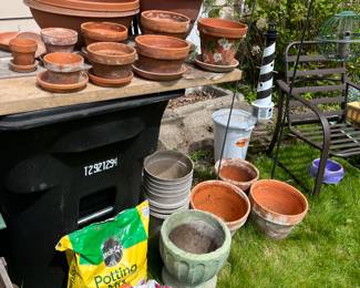 Large variety of clay flower pots and potting mix.
