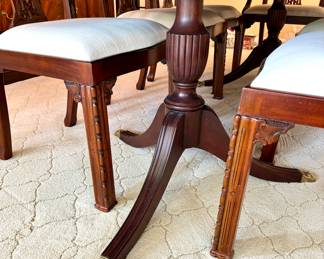 Classic mohagany double pedestal dining table with beautiful claw feet and 10 intricately carved, upholstered chairs, 2 of which are arm chairs. Family has set a reserve at $15,000, although reasonable offers may be considered; closeup of chair leg details and double pedestal table; table: 72x46x29 (without 24" leaf); arm chairs: 24x20x38; side chairs: 23x20x38