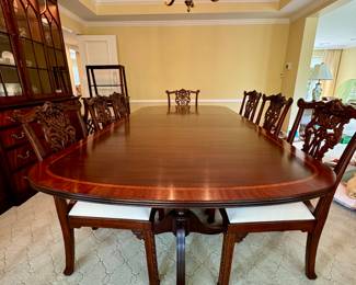 Classic mohagany double pedestal dining table with beautiful claw feet and 10 intricately carved, upholstered chairs, 2 of which are arm chairs. Family has set a reserve at $15,000, although reasonable offers may be considered; table: 72x46x29 (without 24" leaf); arm chairs: 24x20x38; side chairs: 23x20x38