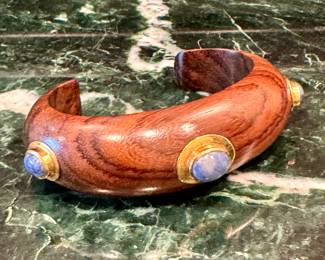 $90; Branch rosewood cuff bracelet with gold and lapis stones
