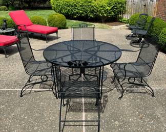 SOLD; Woodard black wrought iron round patio table and 4 rocker arm chairs; table: 47x29; chairs: 28x35x38