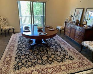 Beautiful oval antique dining table with freshly reupholstered antique side chairs (12); shown with two leaves in