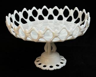 Milk glass fruit compote with a pierced gallery setting on a tri-form stem with a pierced foot