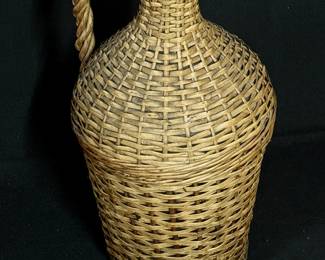 Woven basket over old glass bottle