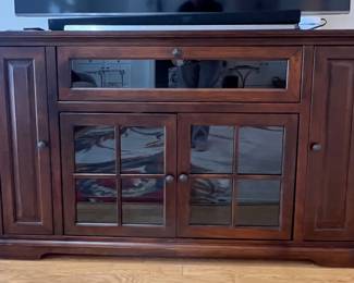 Entertainment unit with glass doors