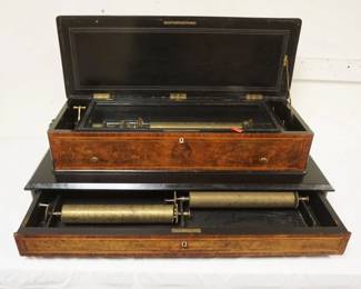 1142	ANTIQUE SWISS CYLINDER MUSIC BOX ON BASE W/DRAWER, CASE BURLWOOD & INLAY W/EBONIZED FINISHED TRIM, DRAWER CONTAINS 2 ADDITIONAL CYLINDER ROLLS, APPROXIMATELY 40 IN X 19 IN X 12 IN HIGH
