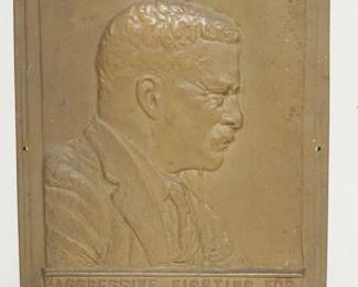 1026	CAST BRONZE PLAQUE THEODORE ROOSEVELT *AGGRESSIVE FIGHTING FOR THE RIGHT IS THE NOBLEST SPORT THE WORLD AFFORDS*, APPROXIMATELY 9 1/2 IN X 12 1/4 IN
