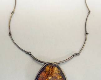 1239	ORANGE AMBER TYPE NECKLACE, APPROXIMATELY 12 IN L, STONE APPROXIMATELY 3 IN X 2 IN W
