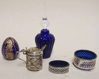 1055	GROUP OF ASSORTED COBALT GLASS ITEMS, 5 PCS. INCLUDING 1 SILVER MINIATURE STEIN, SALT WITH COBALT LINER, COBALT EGG, SALTS AND PERFUME W/STOPPER, TALLEST PC. APPROXIMATELY 6 IN H
