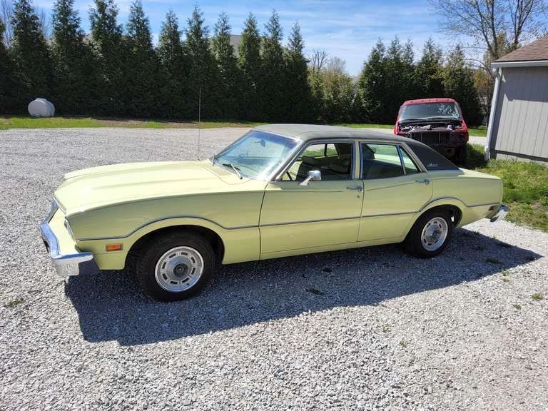Lot 2: 1975 Ford Maverick 4door car, 6cyl engine, auto trans, showing 33,694 miles, pwr steering, pwr brakes, AC & Heat, AM radio, original owner's manual, Vin#: 5K92L137635, original paint, original interior, vinyl top, STARTS, RUNS, DRIVES, HAS TITLE