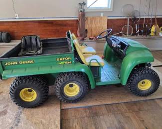 Lot 10: JD Gator 6x4 showing 875 hours, STARTS/RUNS/DRIVES, gas motor, with 2000lb front winch