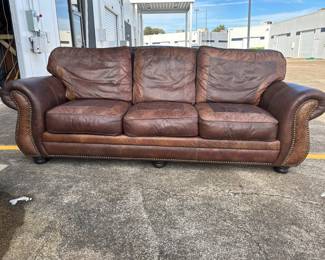 Star Furniture leather couch with patterned leather and western accents