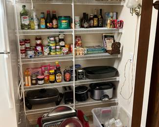 Pantry items including lids, electric appliances and food items - cookbooks on top shelf 