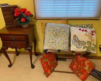 Lots of throw pillows, night stand, jewelry boxes