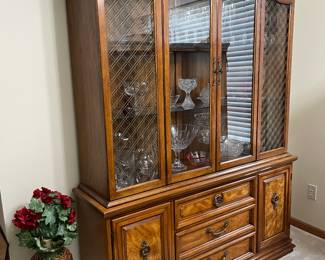 China cabinet full of glassware has matching sideboard