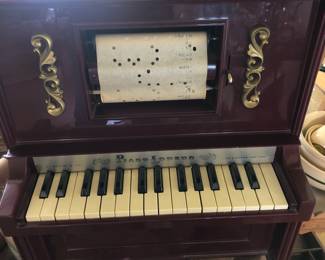  Incredible child’s miniature player piano with original box and player rolls
