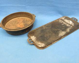 Lot 107. Bottom half of a Lodge Dutch Oven and a #8 Erie 19.5" x 9" griddle