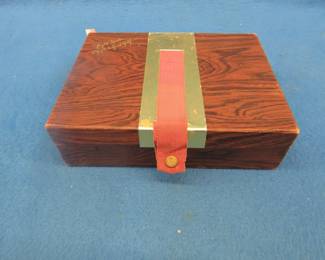 Lot 219. Pens and pencils in an old golf ball box