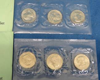 Lot 157. 1979 and 1980 US Mint Souvenir Susan B. Anthony Dollar sets, each with three dollar coins