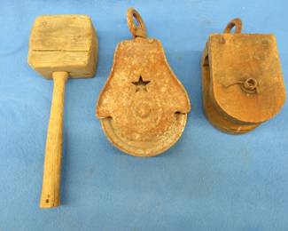 Lot 384. Cast iron pulley,  wooden pulley, and a homemade wooden hammer