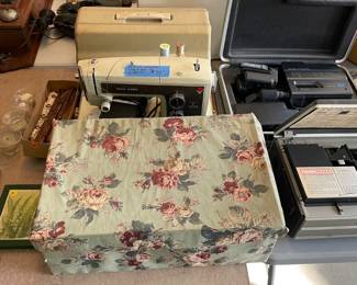Sears sewing machine w/case and box full of sewing items.