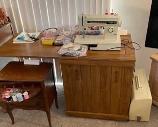 Kenmore sewing machine and sewing cabinet.  Comes with a case and many additional sewing items.  