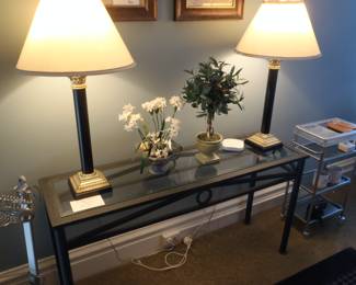 Fine contemporary metal and glass hall or sofa table. Very desirable black metal and brass tall lamps.