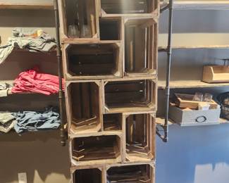 Wooden crate stacked cubbies and wood/metal industrial shelving for merchandise display