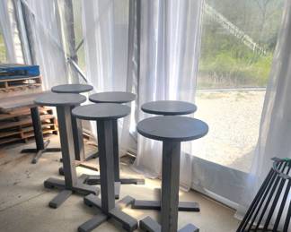 1' round wooden high-top tables and several pallets 