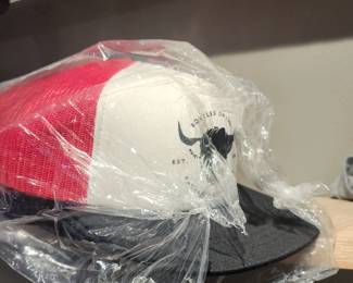 Hats, hats and more hats! Bull Creek Distillery advertising including large and small signage, menus, and promotional items.