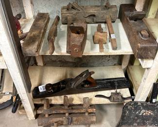 Various wood working planes: the one in the middle... the two foot long Bailey #8 and to its right is a Stearns spoke shave. Others are coffin, plough block and more...