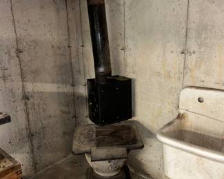 2 pot stove with piping and a heat reflector unit.