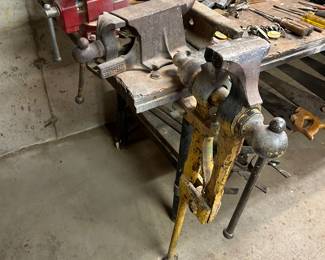 upfront is a leg vise, two bench vises, railroad tie ‘anvil’