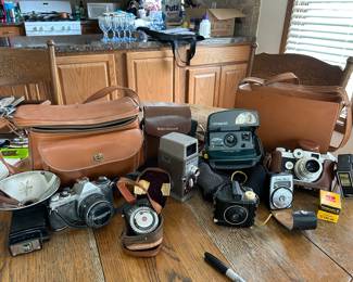 Cameras & accessories: from the left to the right... 35mm Pentax, camera carrying bag, light meter, Bell & Howell 252 movie camera with case, Kodak Baby Brownie, Poliroid 1 Step w/ case, Sunset Inittec light meter, Argus 35mm and more...