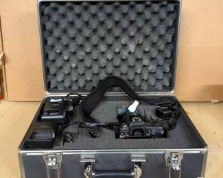 Nikon D7000 Camera Body With AF-S DX Nikkor 18-55mm f/3.5-5.6 G VR Lens, Battery, And Battery Charger In Padded Hardsided Case