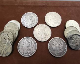 assortment of antique u.s. Morgan dollars, walking liberty half dollars, and other u.s. silver coins.