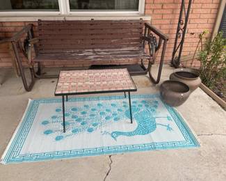 Mosaic tile ceramic coffee table, Wood and metal swinging bench, Copper pots, Outdoor peacock accent rug, Metal birdhouse