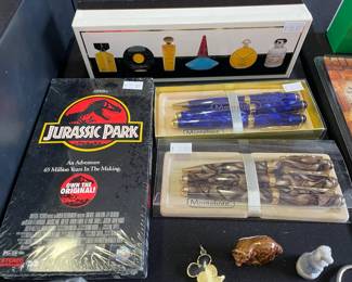Parfums Paris Coffret 6 eaux de toilette, Jurassic Park 1993 sealed VHS tape, Montefiore Pens, Walt Disney Productions Mickey Enamel Pendant, Raccoon Wade figurine, Circus Poodle Wade figurine