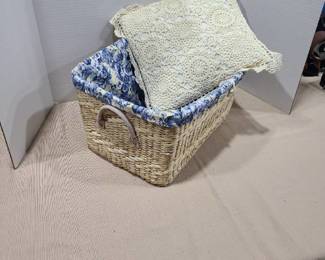 Lined basket with lacy throw pillow.