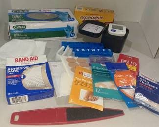 Miscellaneous bathroom items. Corn cushions, wrist blood pressure machine, pill cutter and more